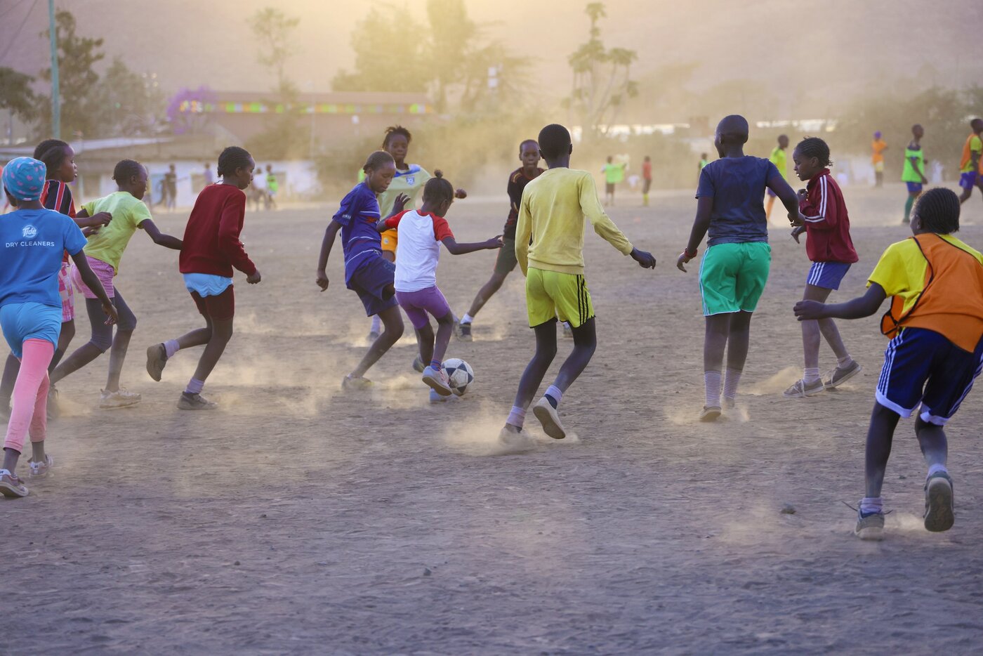 TAFA youth playing football at sunset in Kasarani