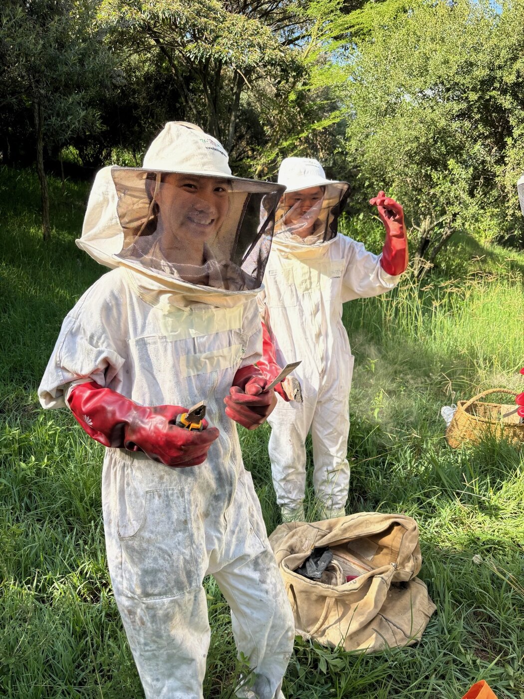 A veteran beekeeper with Karis at the Bee the Change apiary
