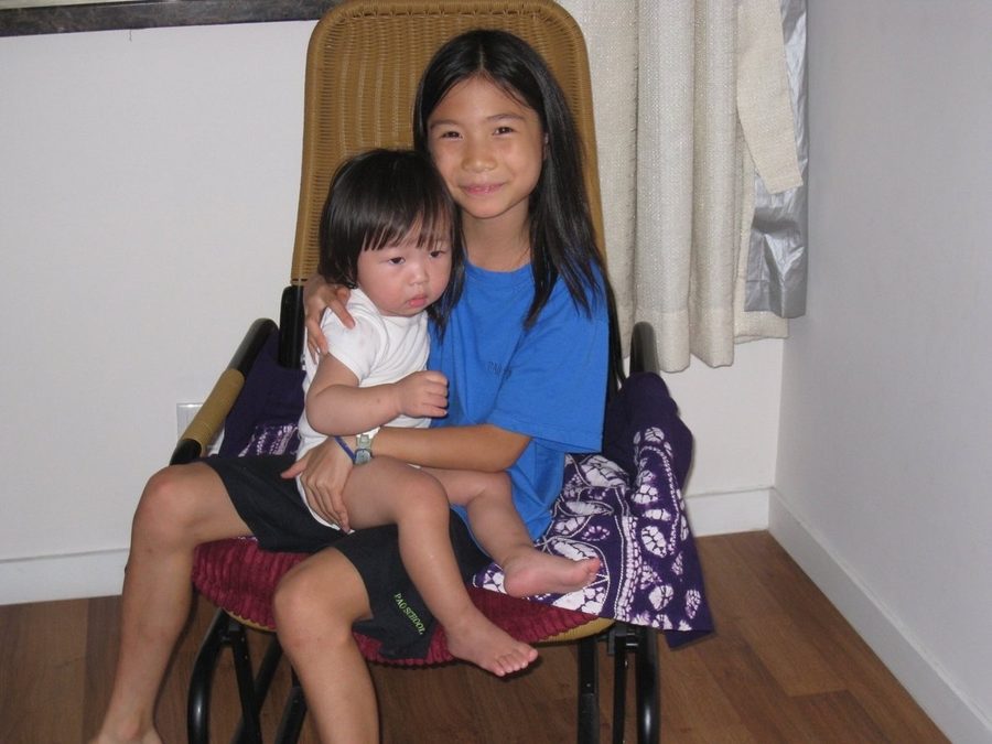 Young Karis holding her baby sister Ana