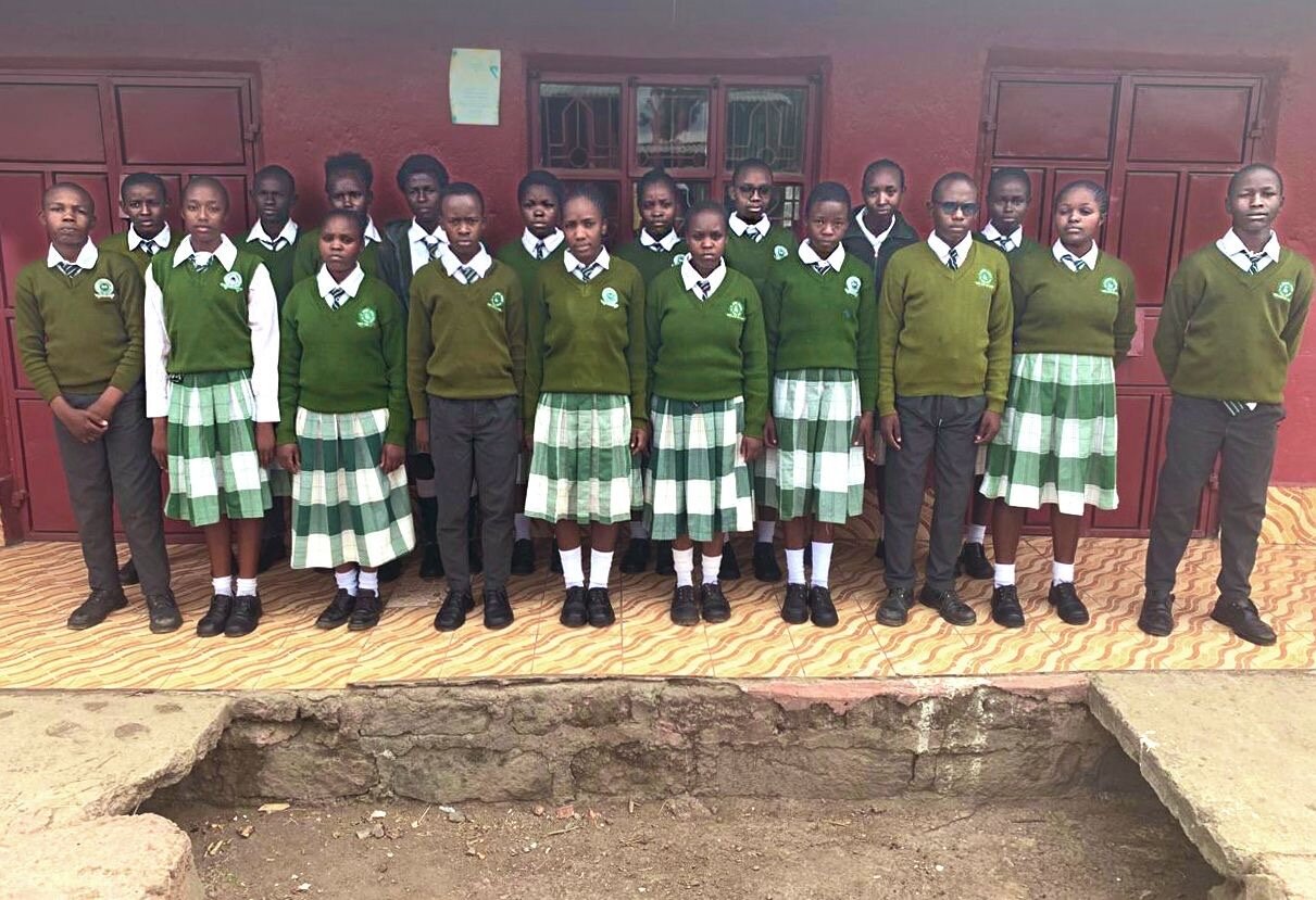 Wezesha students in school uniforms outside the education center in Kasarani