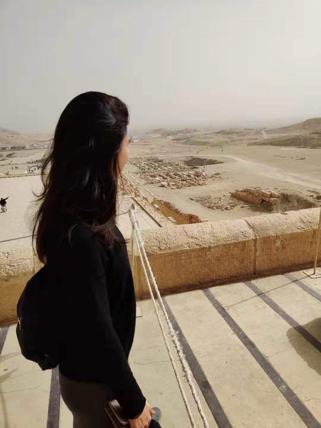 Karis looking out across an ancient ruined landscape, alone with the weight of what is ahead